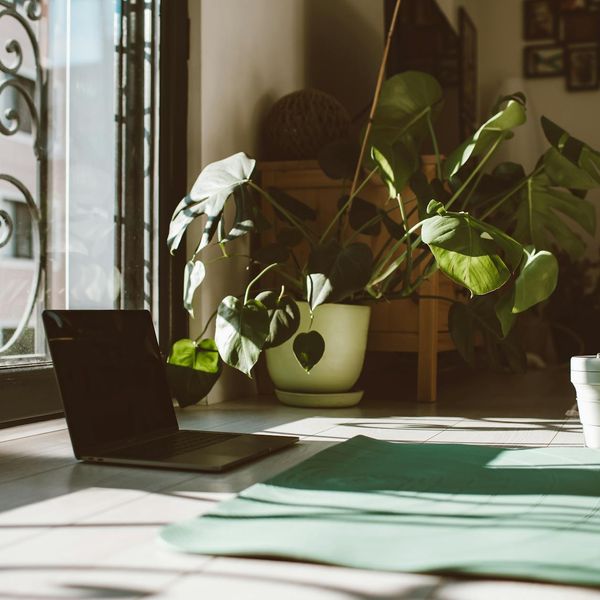 A yoga mat rolled out in a quiet space near a window.