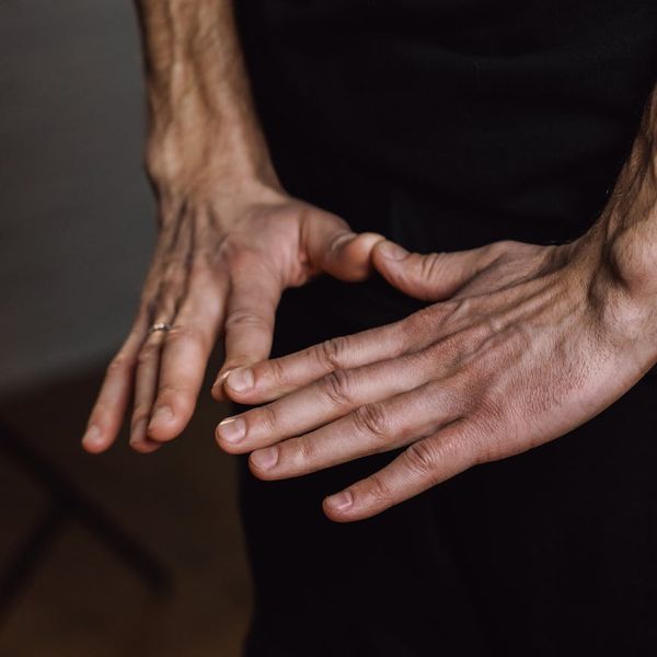 Close-up of hands in a specific yoga mudra gesture.